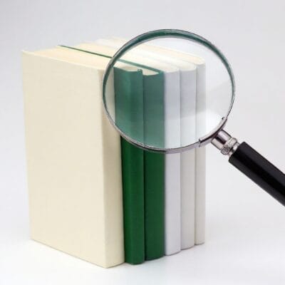 Magnifying glass on stacked books