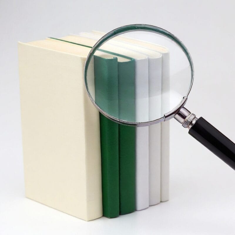 Magnifying glass on stacked books