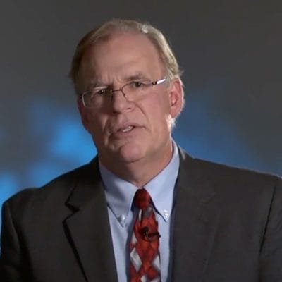 Man in suit giving a speech.