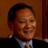 Smiling person in formal attire, indoors.