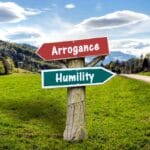 Signpost pointing to Arrogance and Humility in countryside