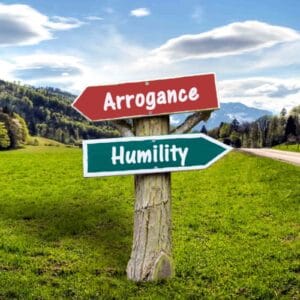 Signpost pointing to Arrogance and Humility in countryside