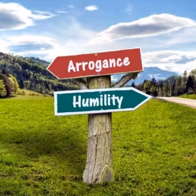 Signpost pointing to Arrogance and Humility in countryside